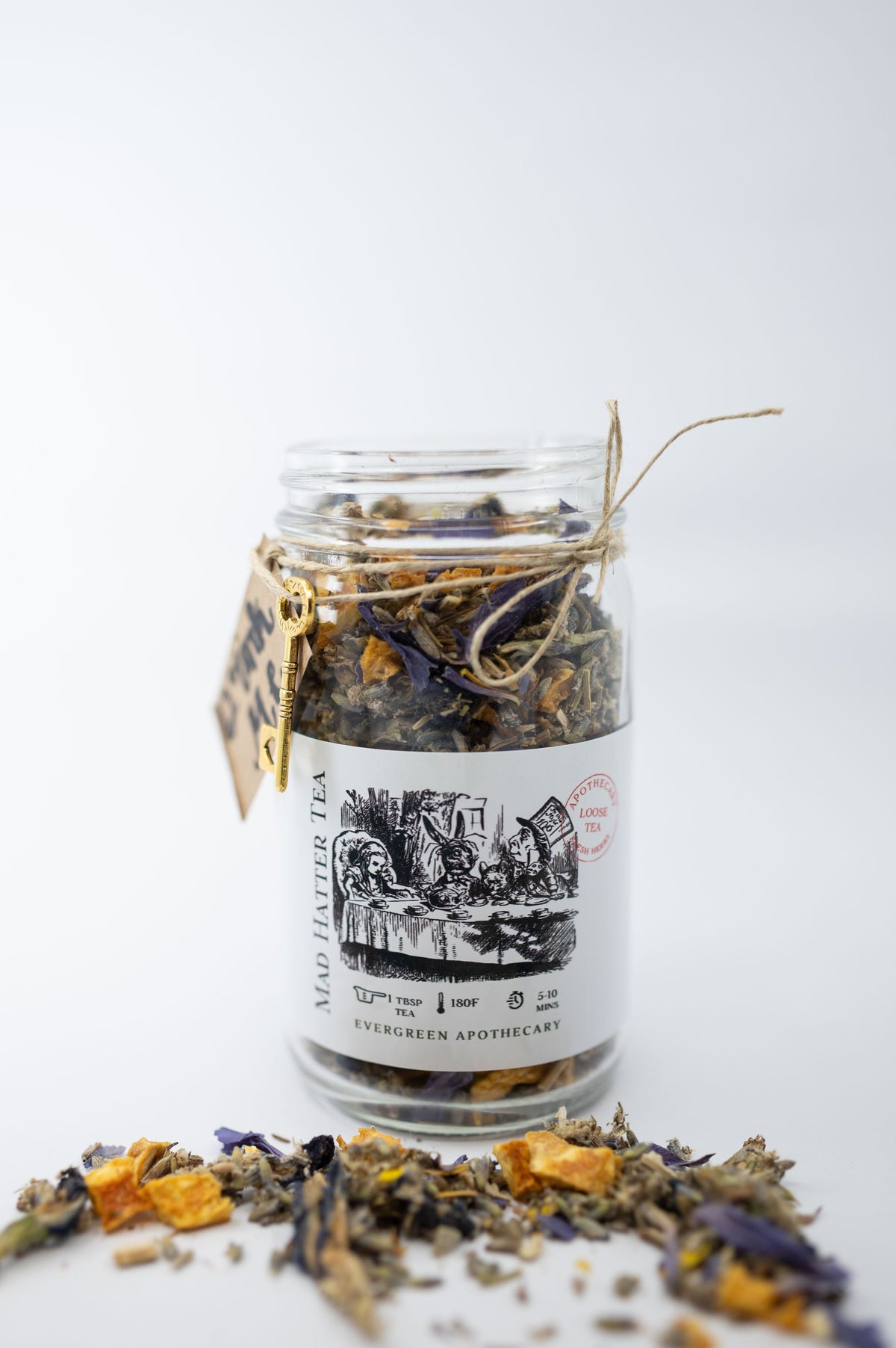 Jar of dried herbs with a label on a white background