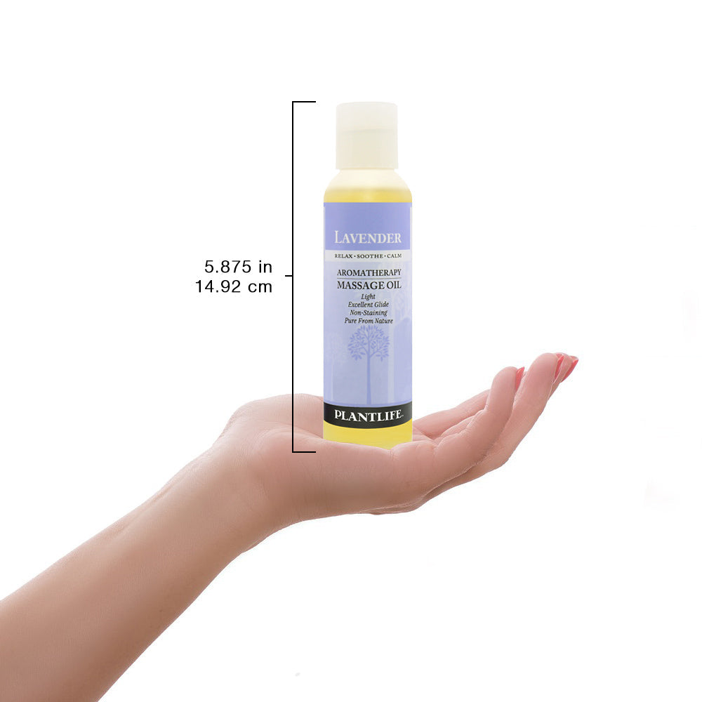 Bottle of Plantlife lavender aromatherapy massage oil held in a hand with measurements displayed.