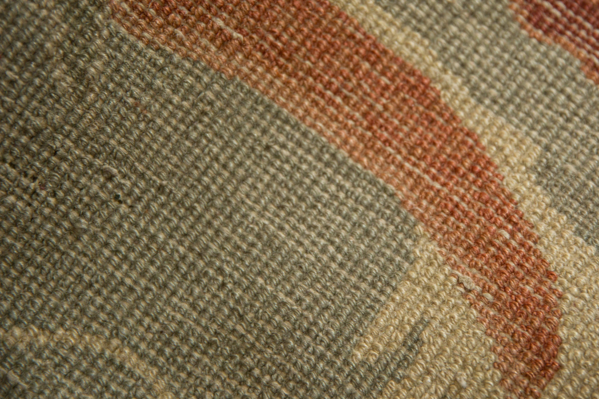 Close-up of a textured fabric with a wavy pattern in earthy tones.