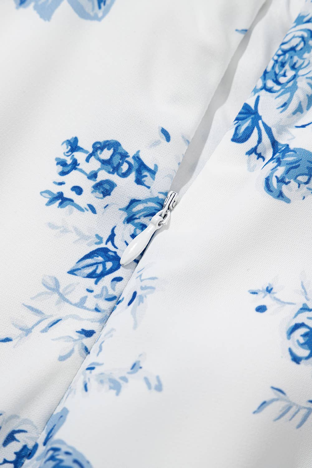 Close-up of a white fabric with blue floral patterns