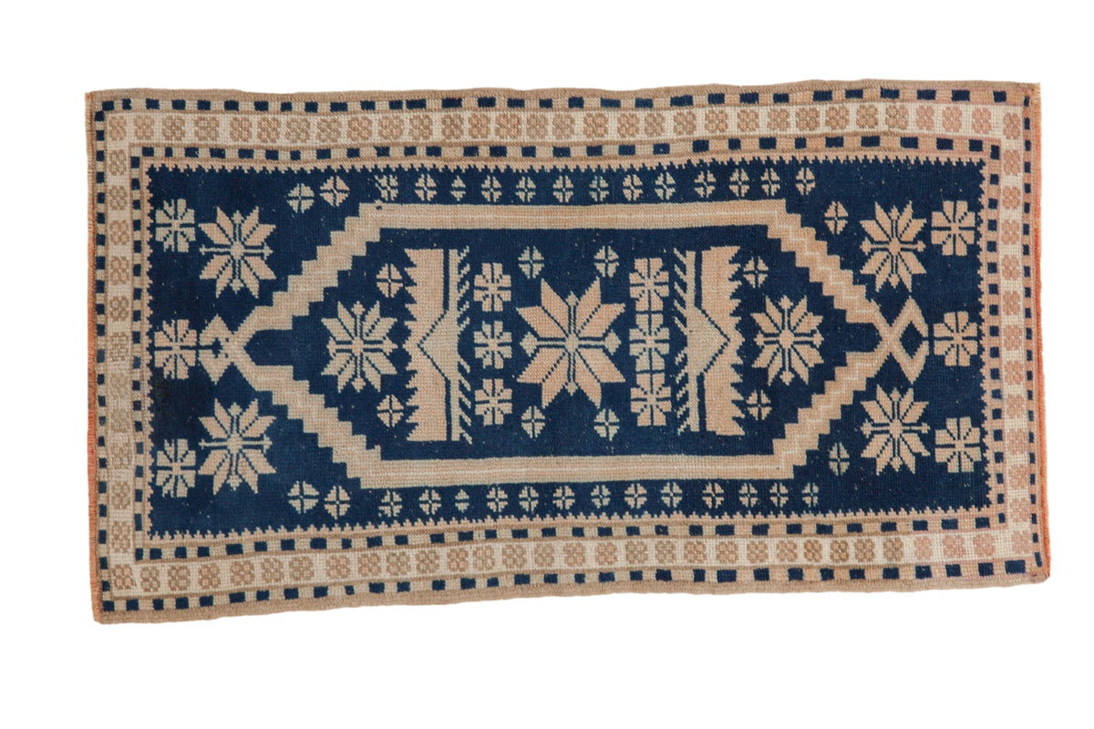 Navy blue and beige patterned rug on a white background