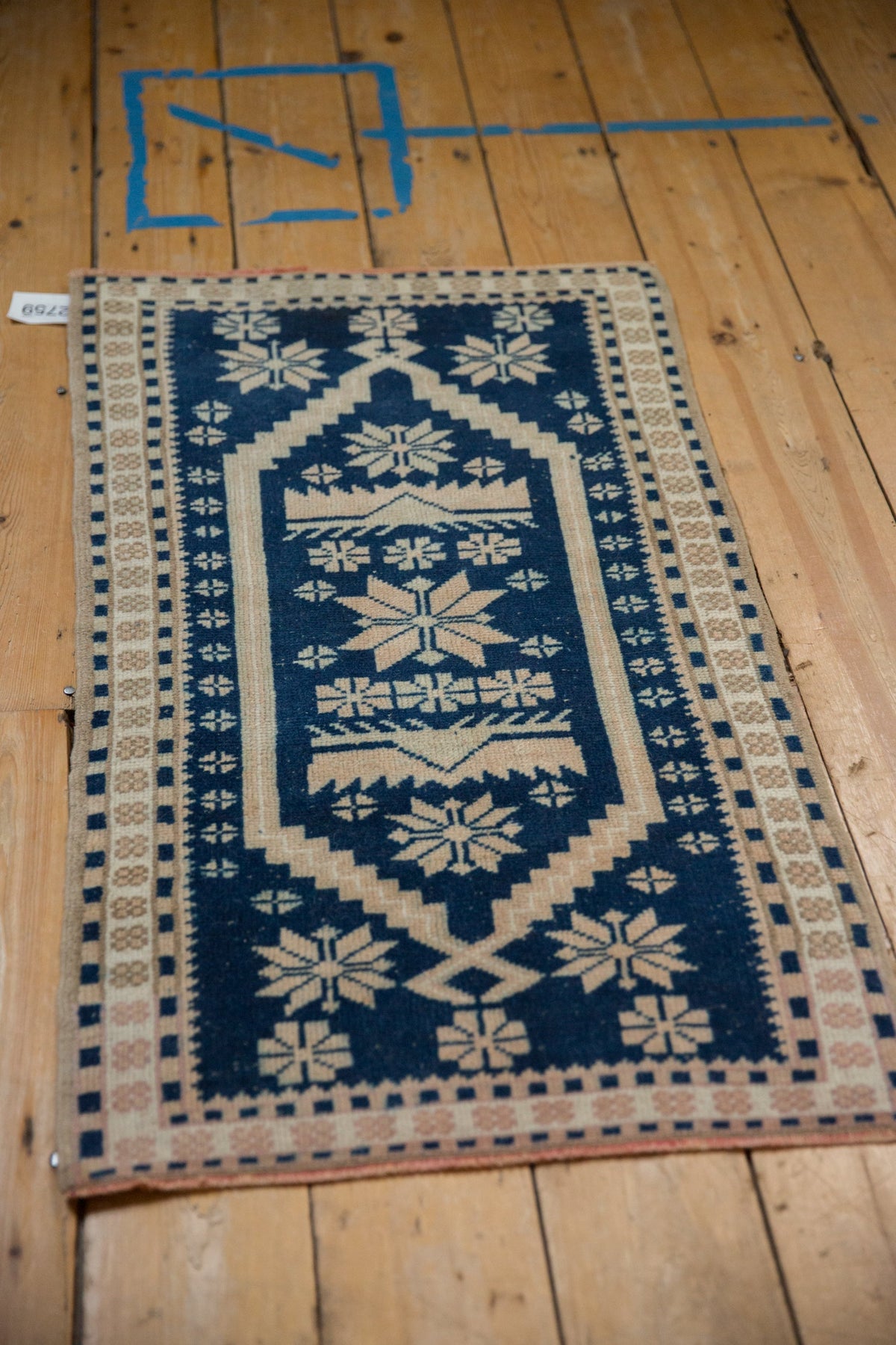Decorative rug with geometric pattern on a wooden floor