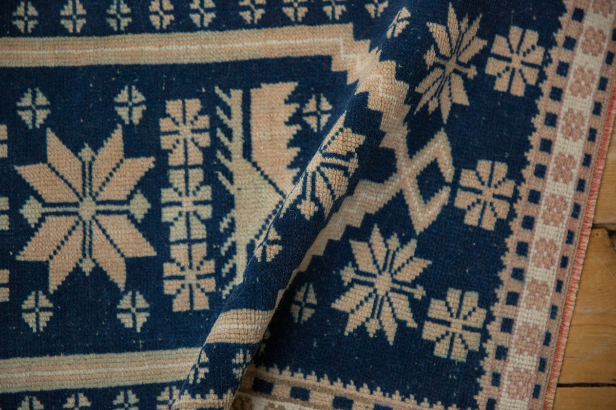 Close-up of a blue and beige patterned fabric with geometric designs.