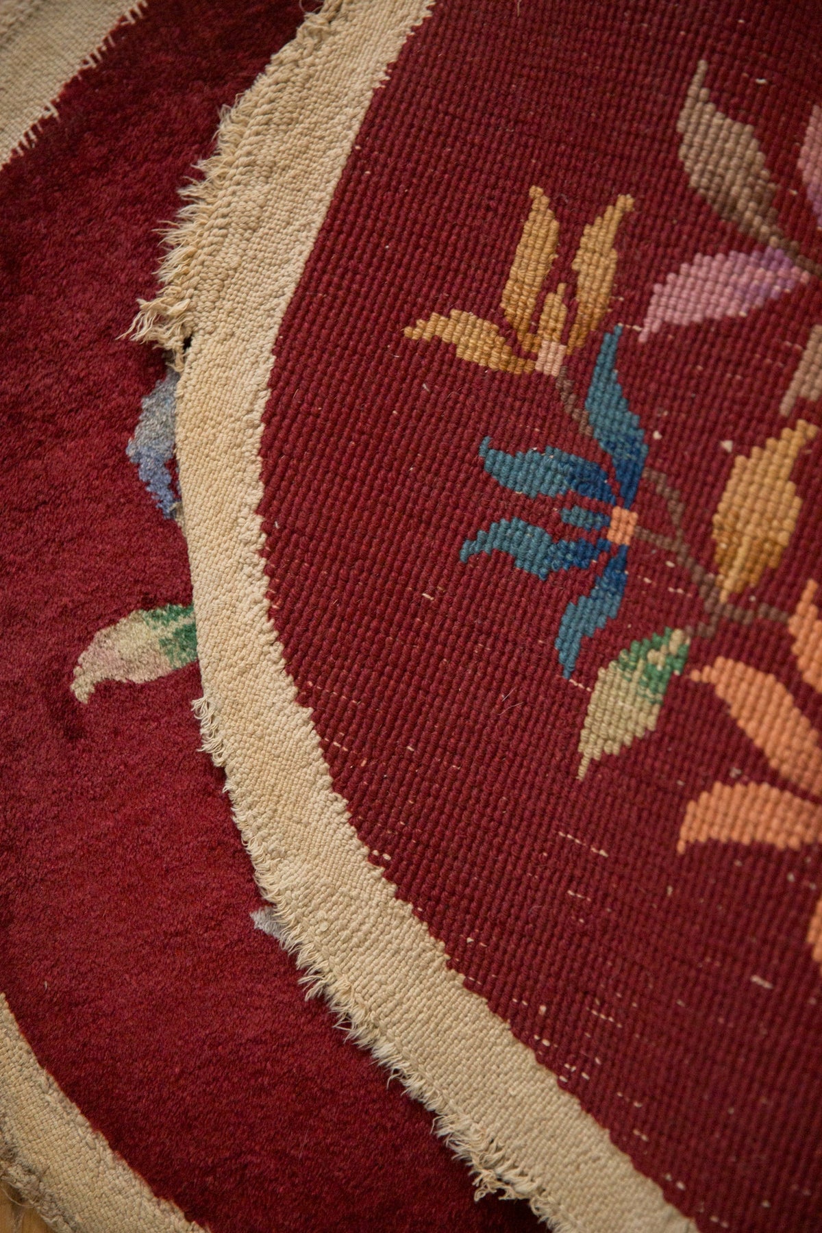 Close-up of a red floral-patterned rug with a beige border