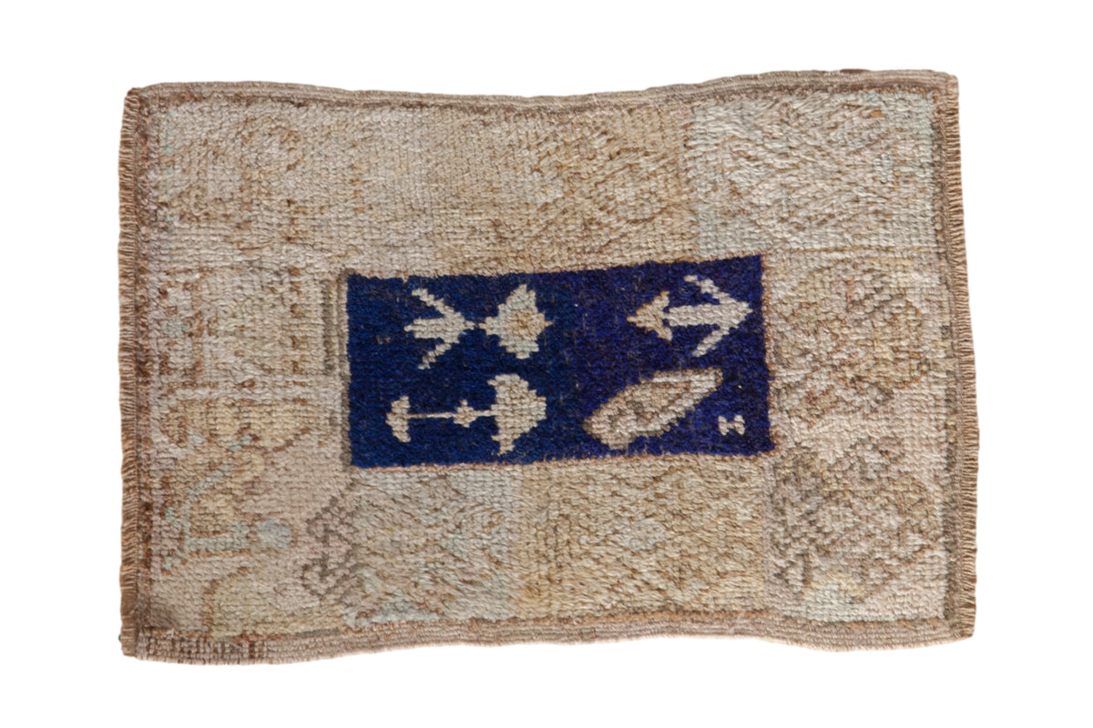 Textile with a blue square featuring white anchor designs on a beige background