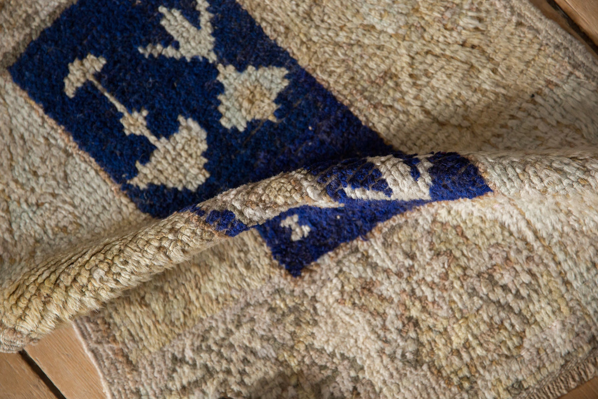 Close-up of a textured rug with blue and beige patterns