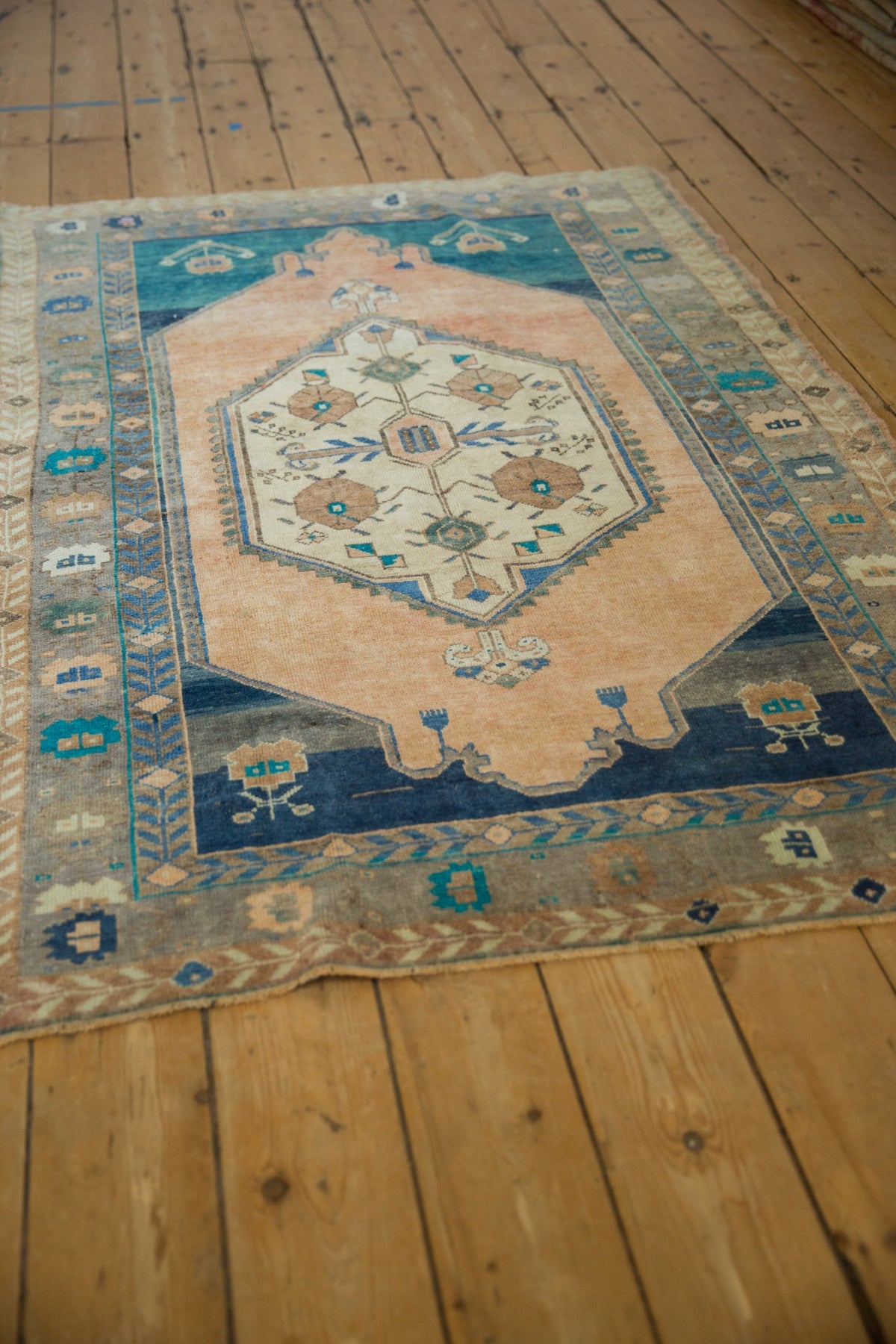 Decorative rug with intricate patterns on a wooden floor