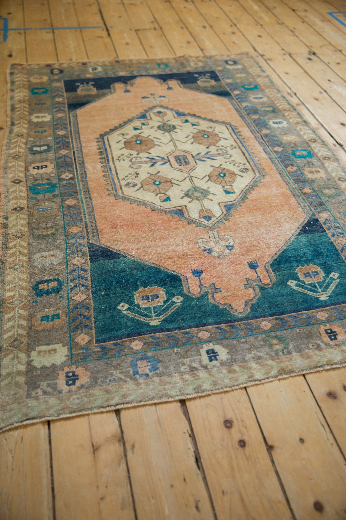 Vintage rug with intricate patterns on a wooden floor