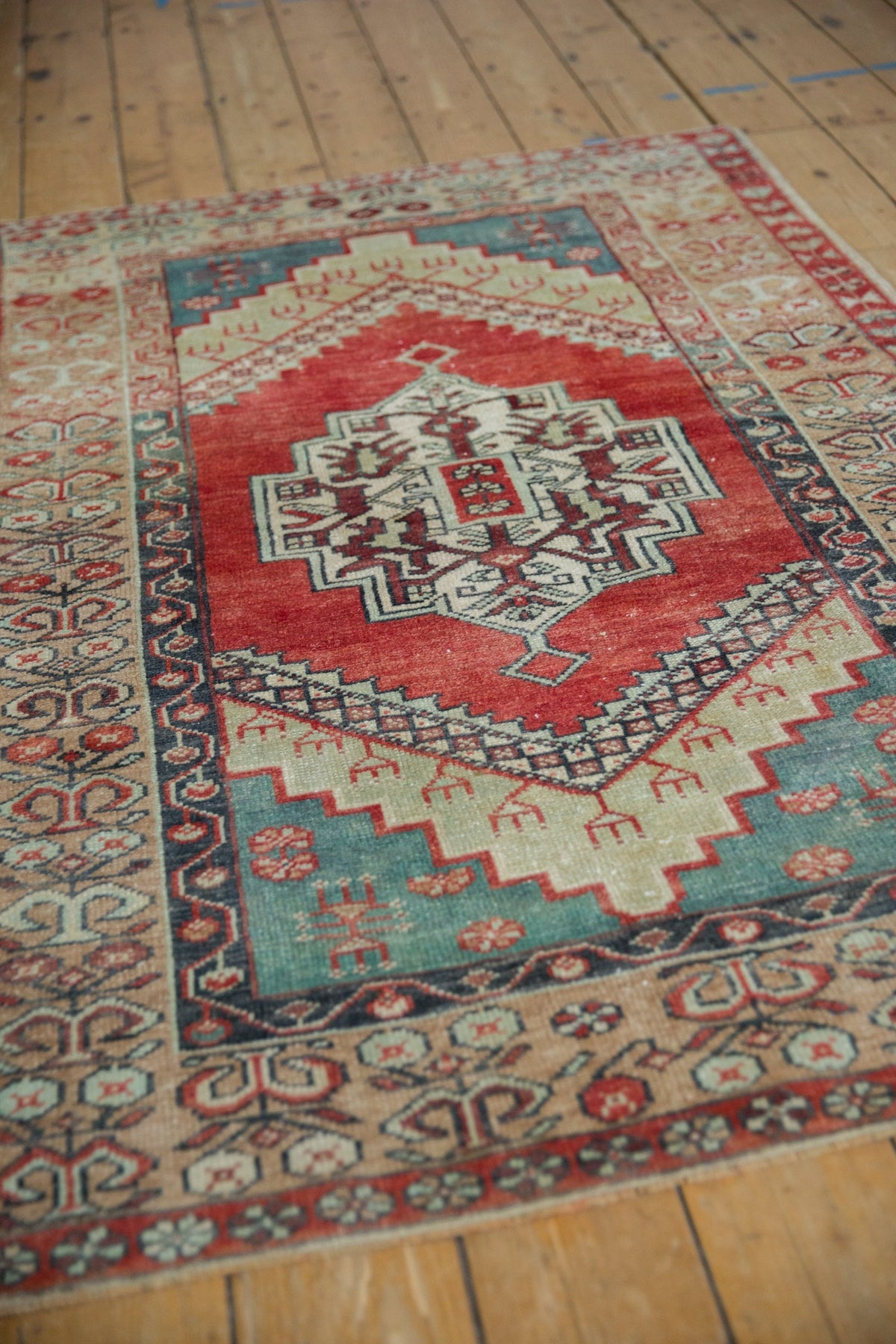 Traditional patterned rug on a wooden floor