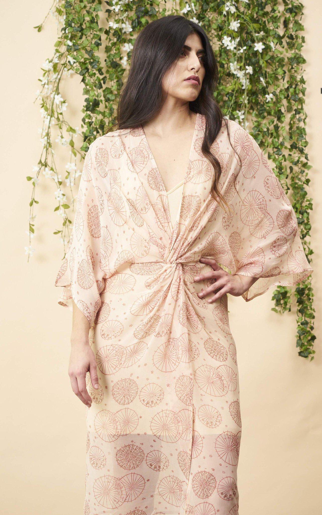 Woman wearing a patterned dress with a floral background