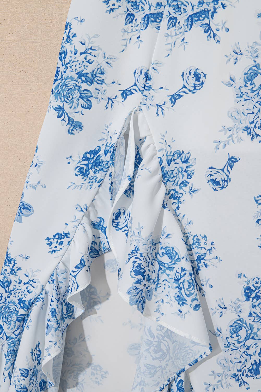 White fabric with blue floral pattern on a beige background