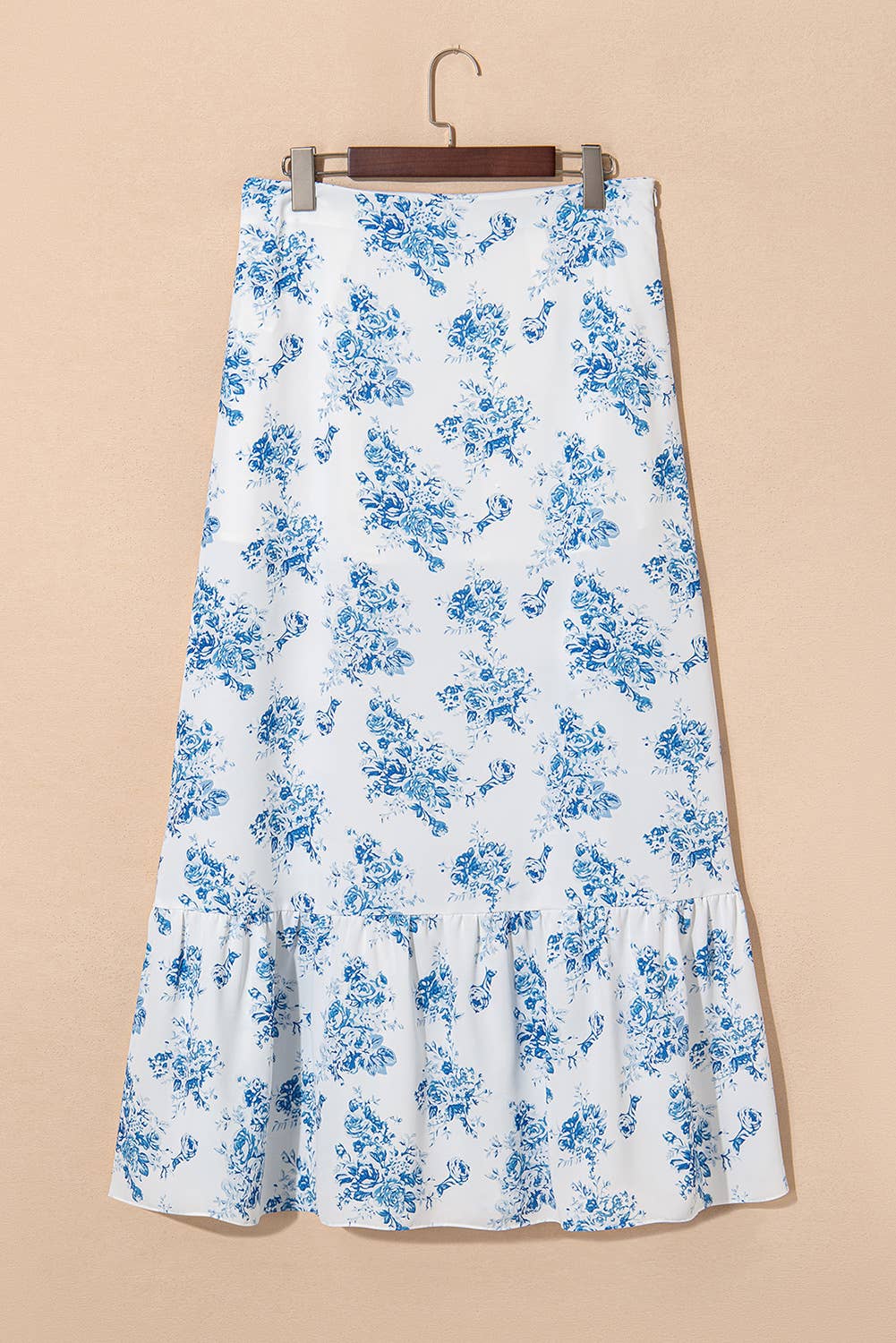 White skirt with blue floral pattern on a beige background