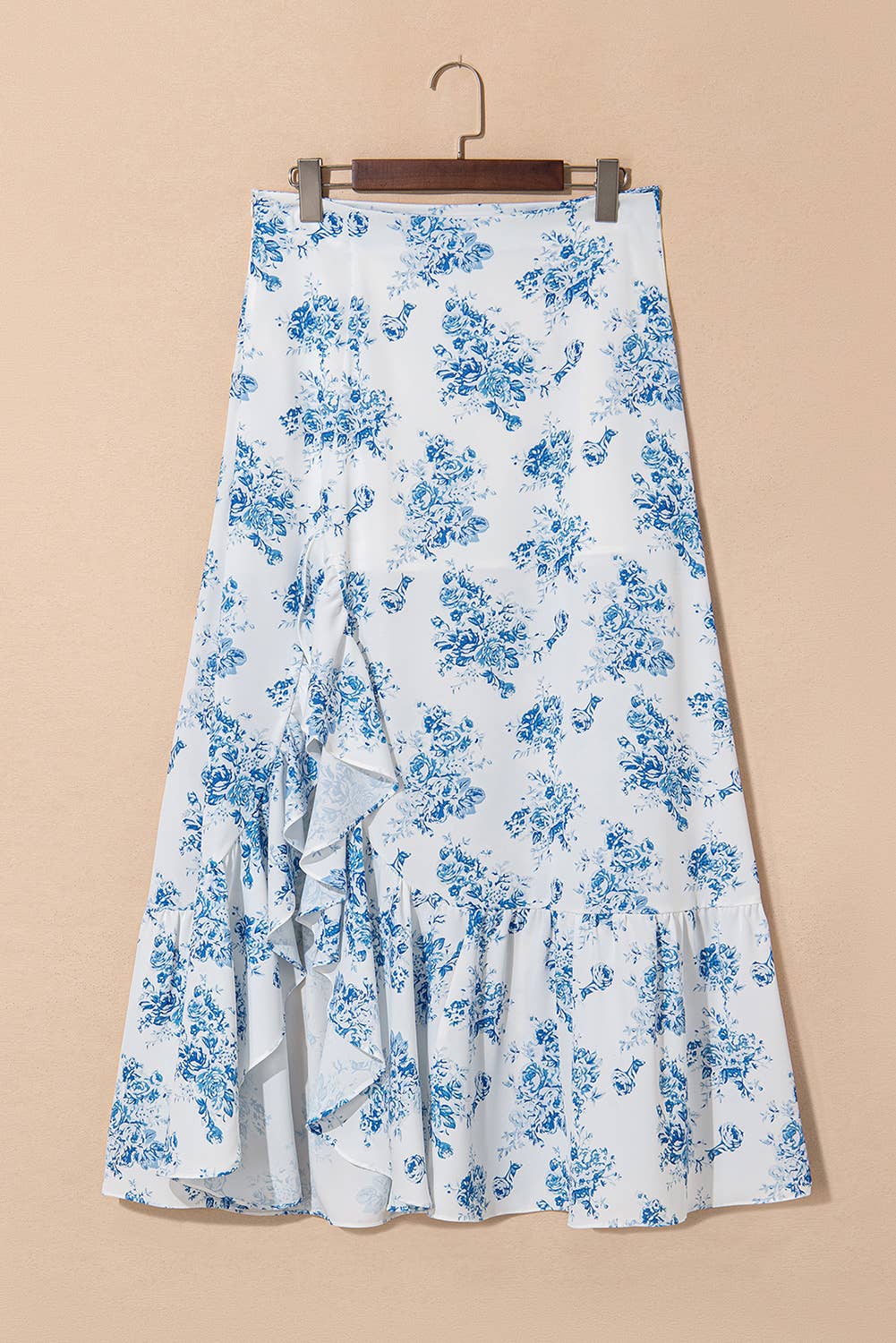White skirt with blue floral pattern on a beige background