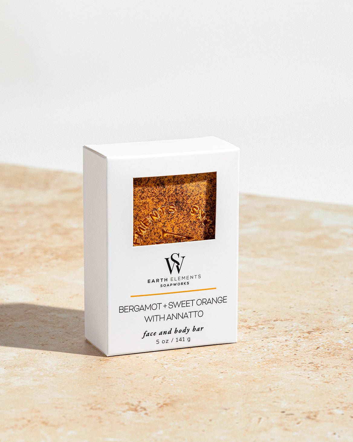 Soap bar packaging with visible soap inside on a light wooden surface