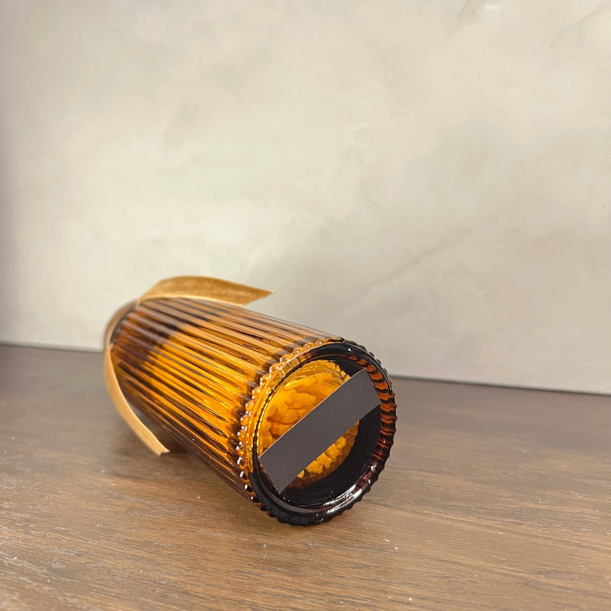 Brown cylindrical object on a wooden surface
