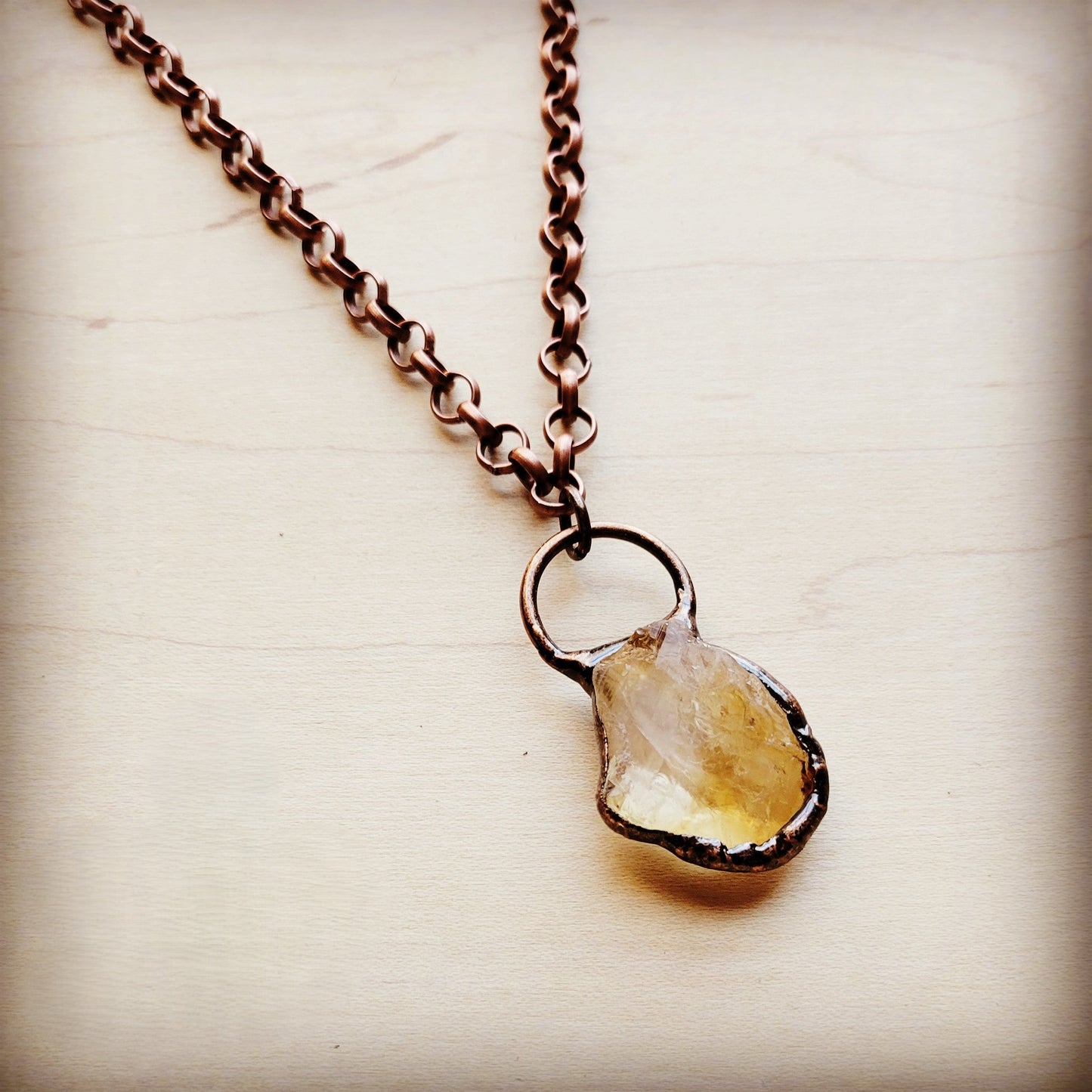 Necklace with a teardrop-shaped pendant on a light background