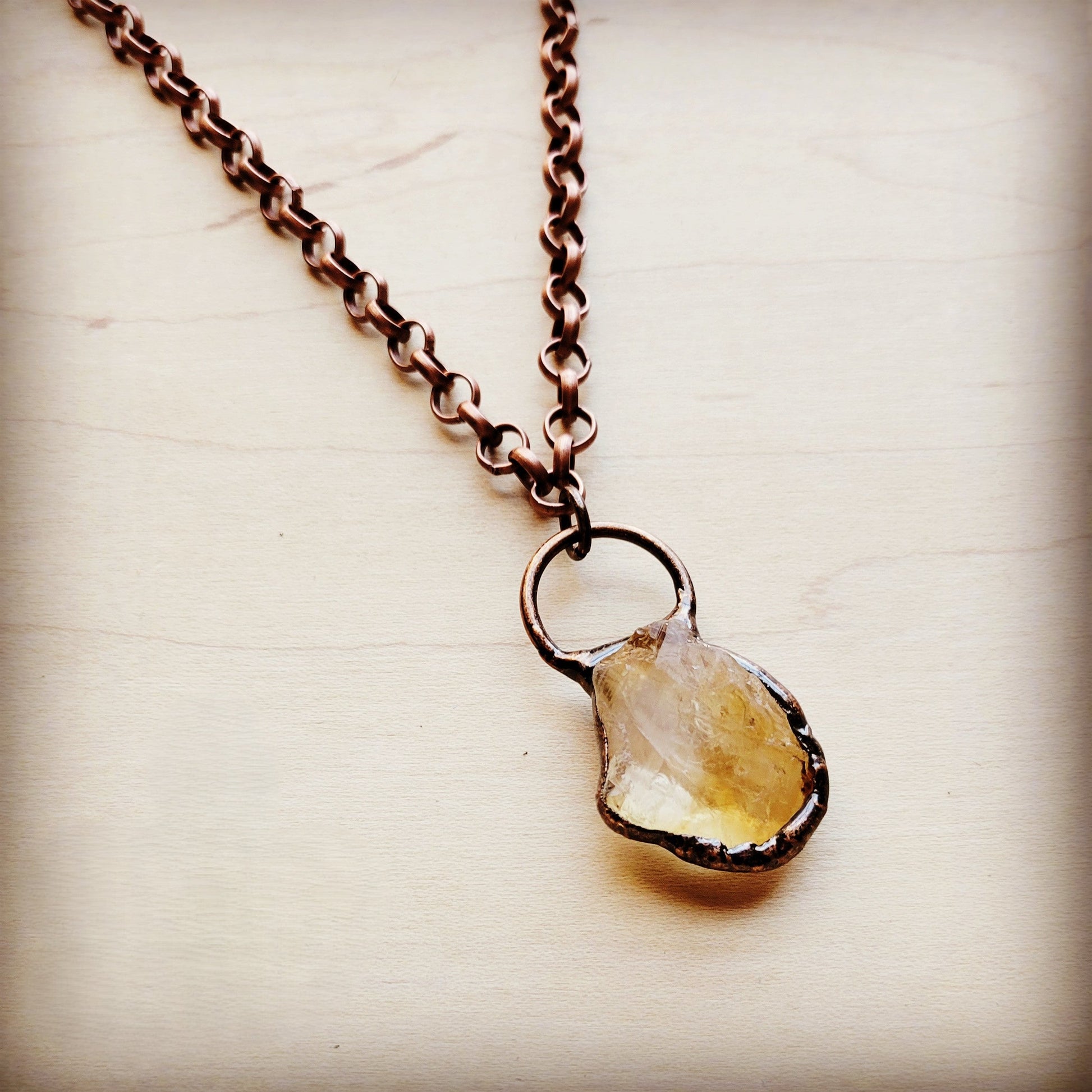 Necklace with a teardrop-shaped pendant on a light background