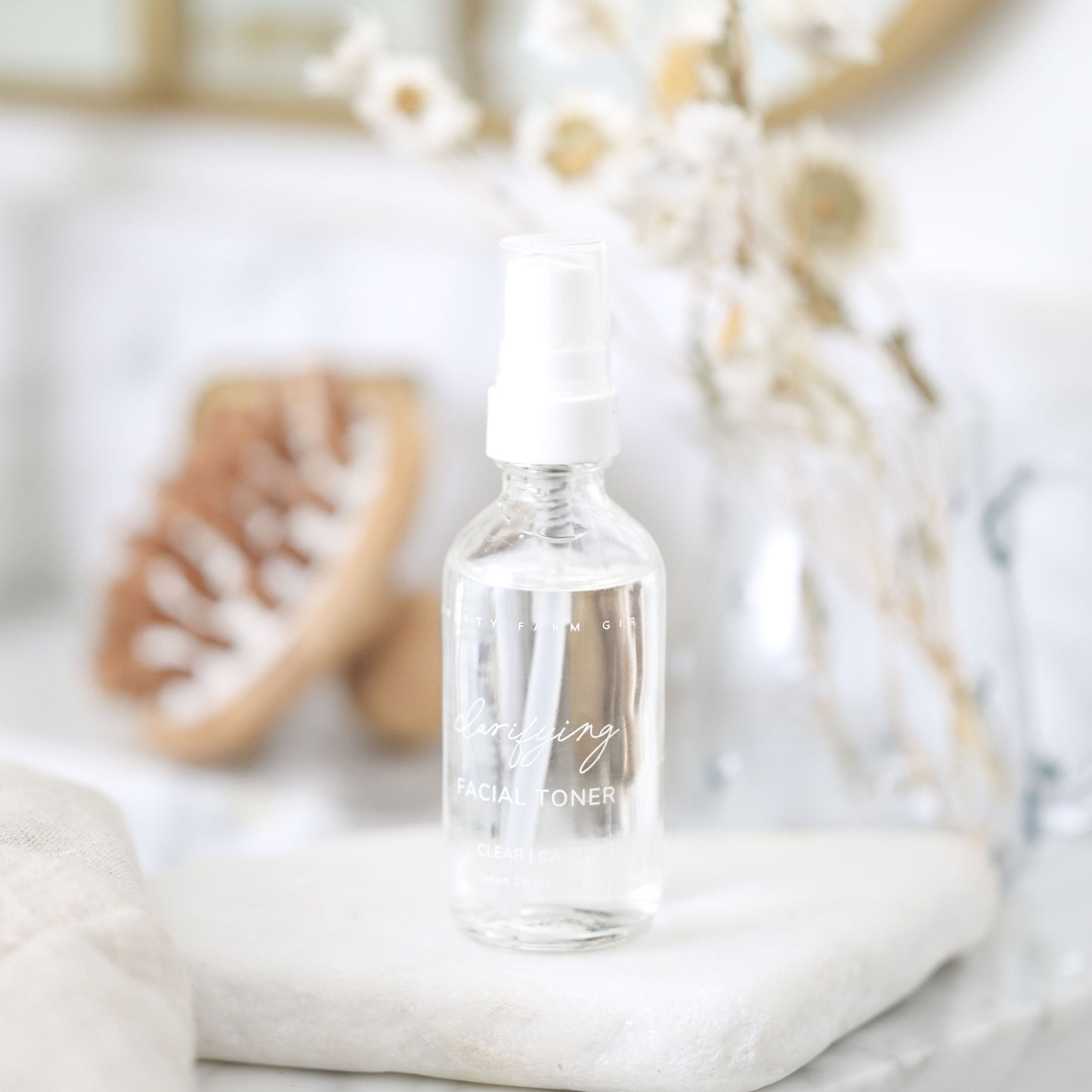 Clear bottle with dropper labeled 'Toning' on a neutral background
