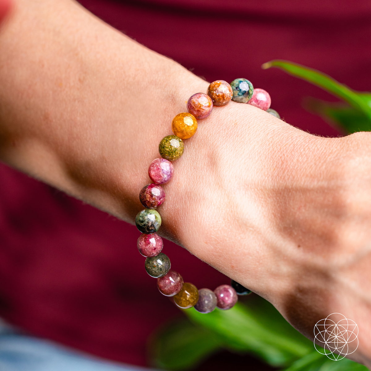 Multicolored beaded bracelet on a wrist with a blurred background