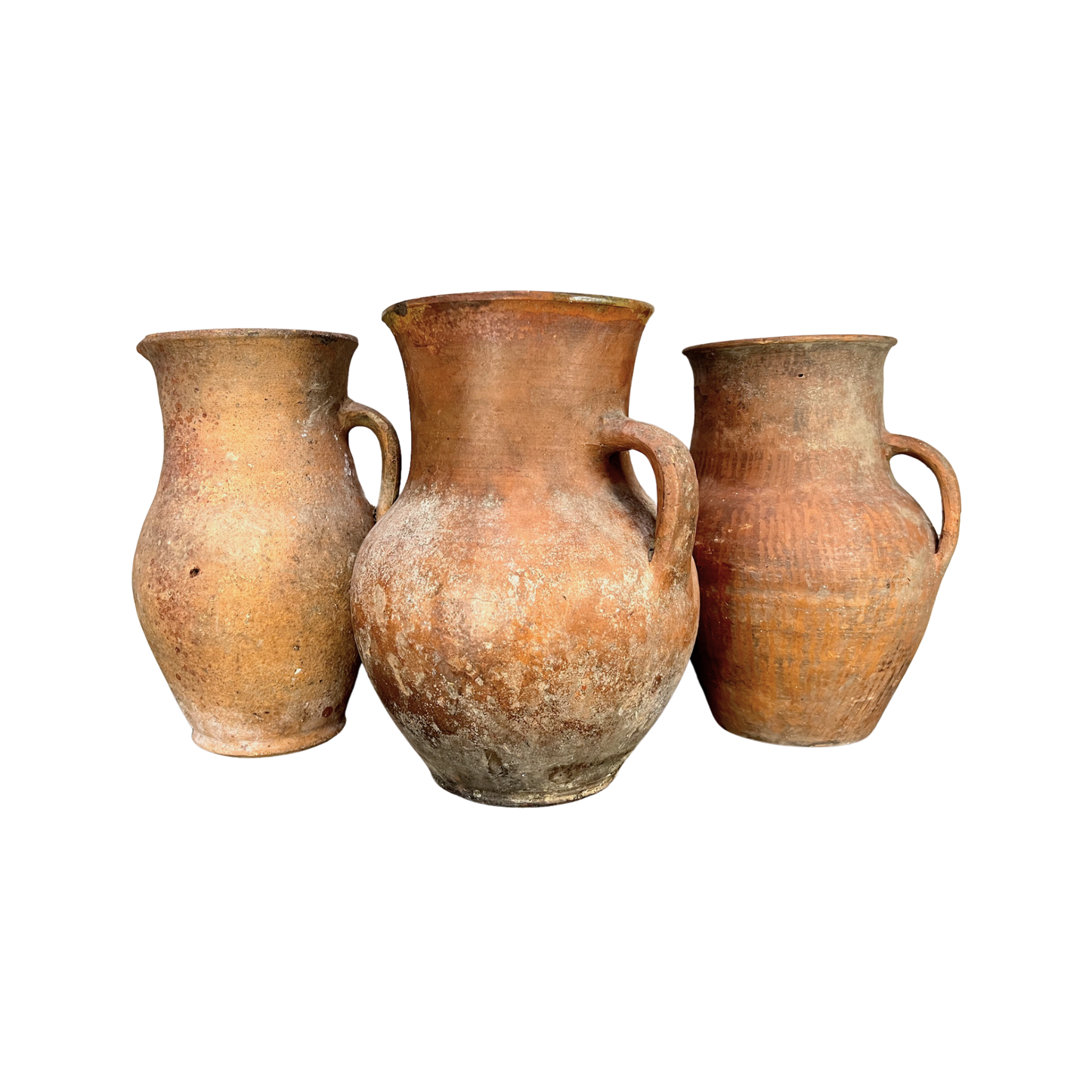 Three terracotta pots of varying sizes on a white background