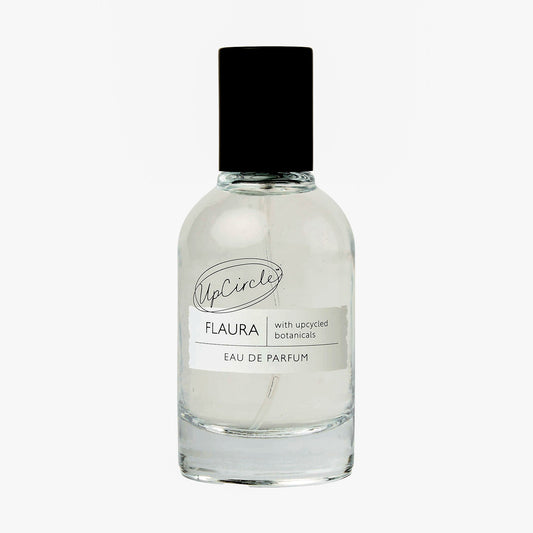 Clear glass perfume bottle with black cap on a white background