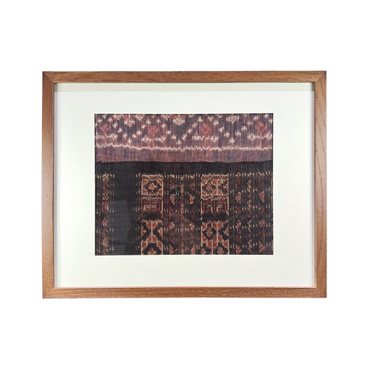 Framed textile with intricate patterns on a white background