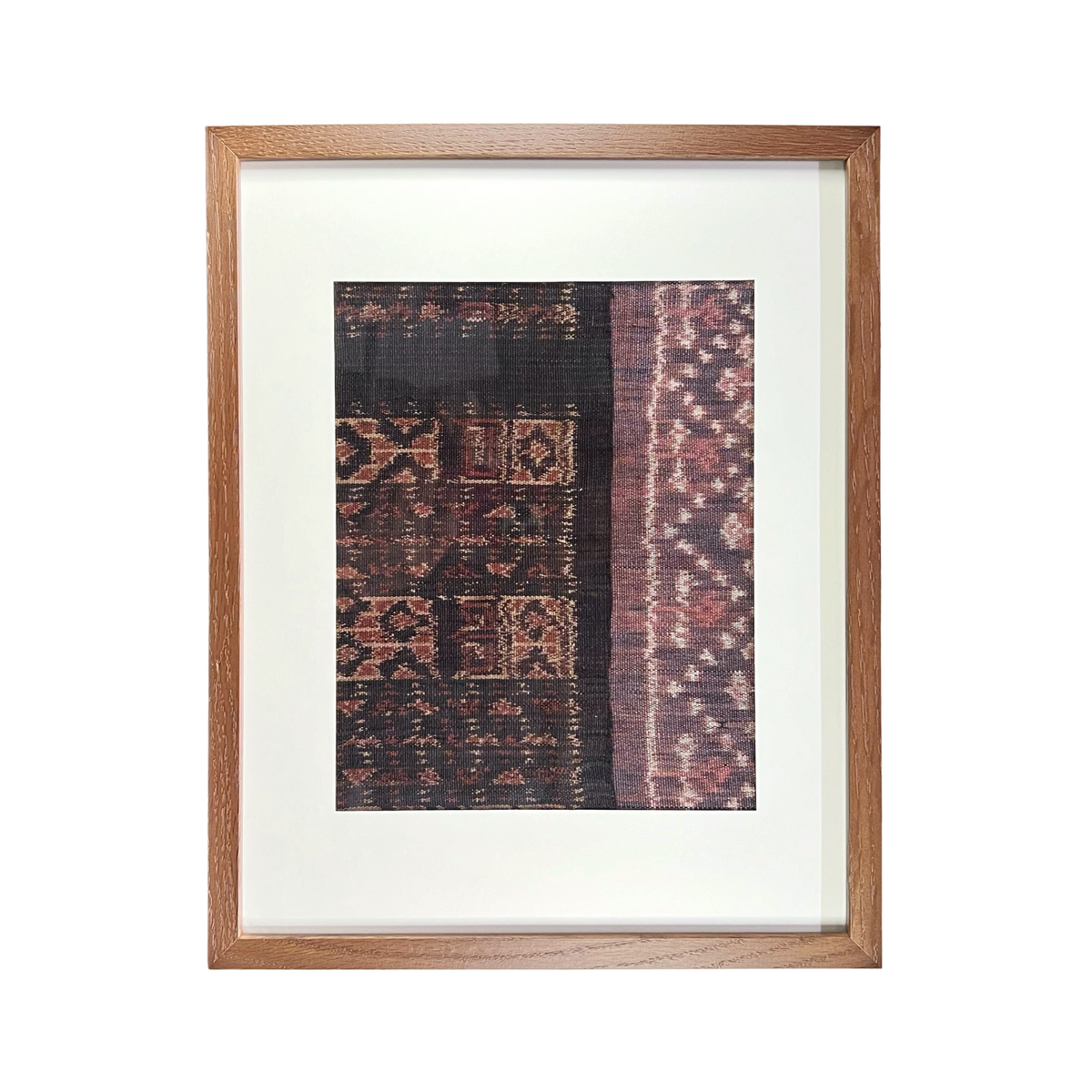 Framed textile with intricate patterns on a white background