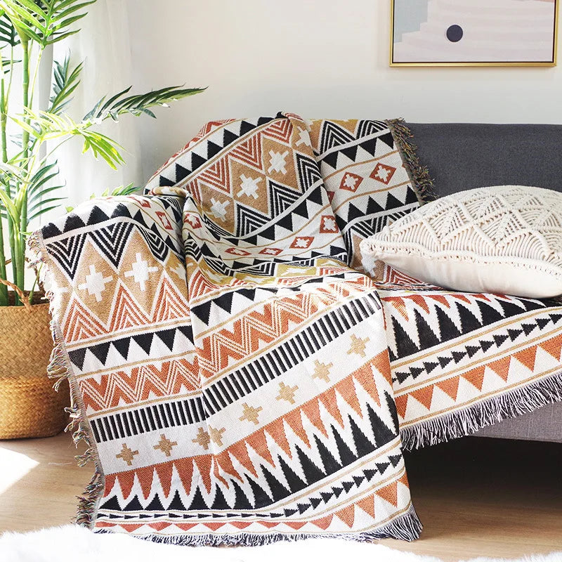 Decorative pillows with tribal patterns on a sofa in a living room setting.