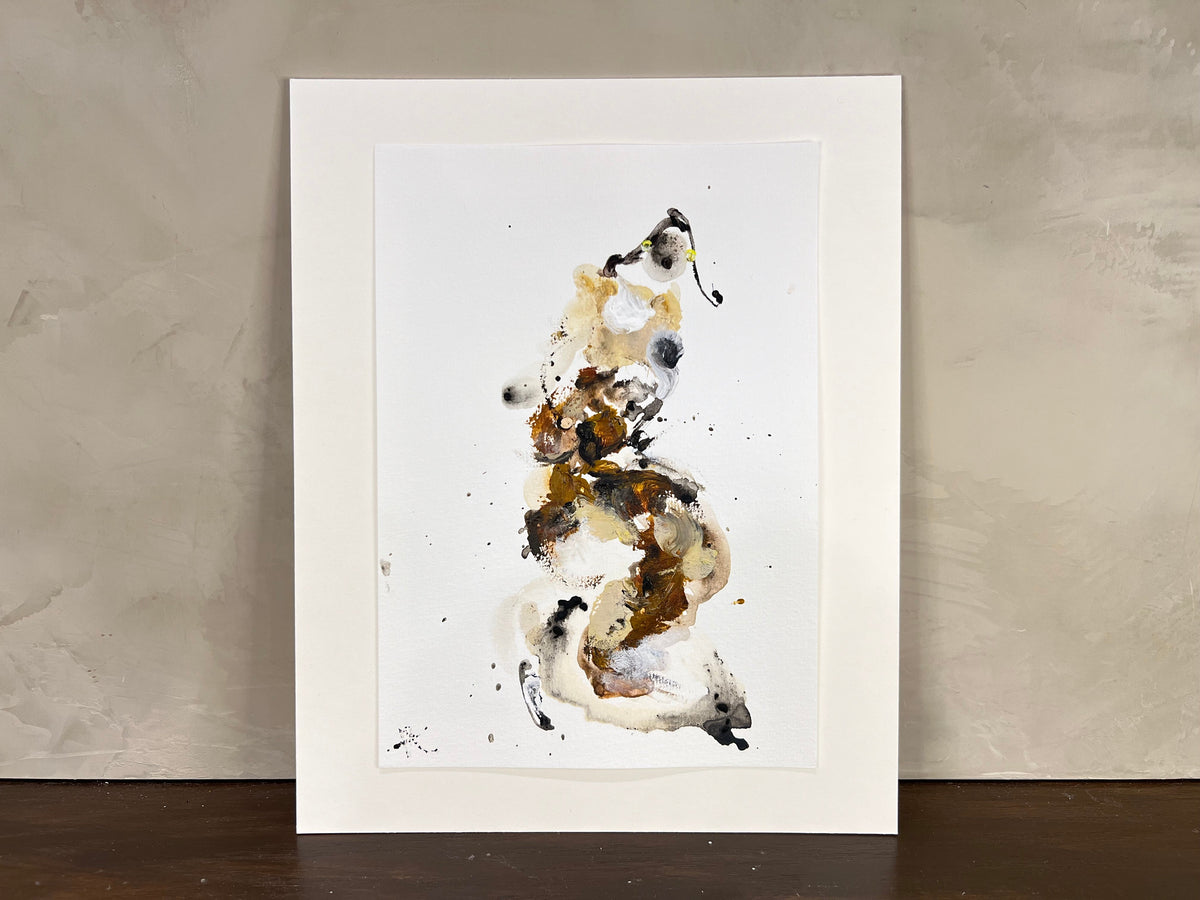 Framed abstract art print on a textured wall