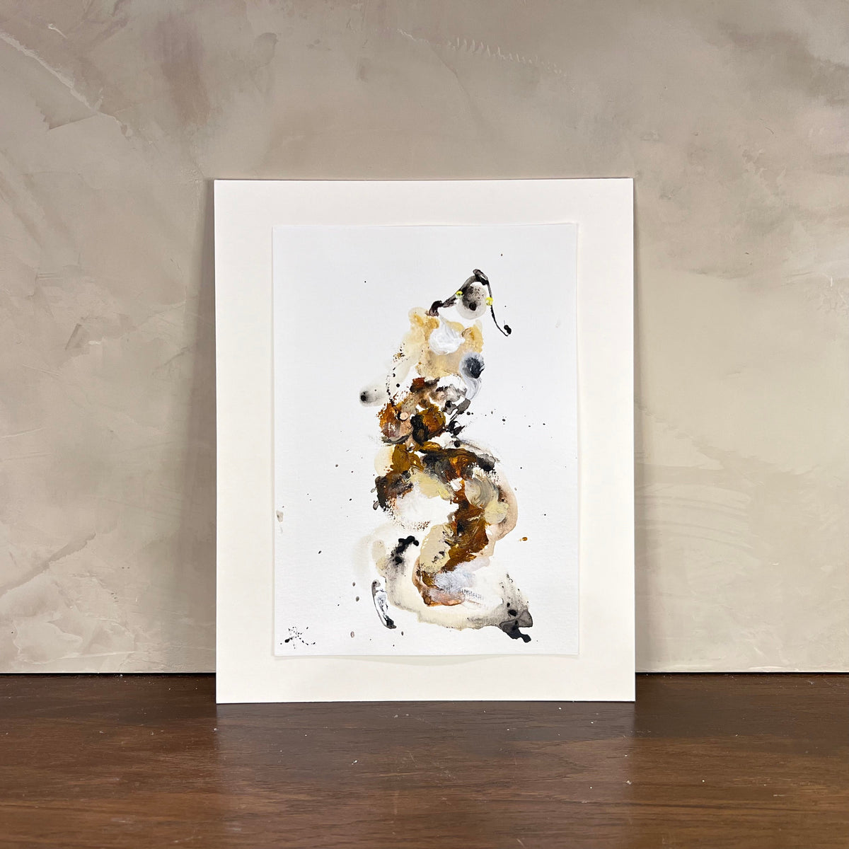 Framed abstract art print on a textured wall