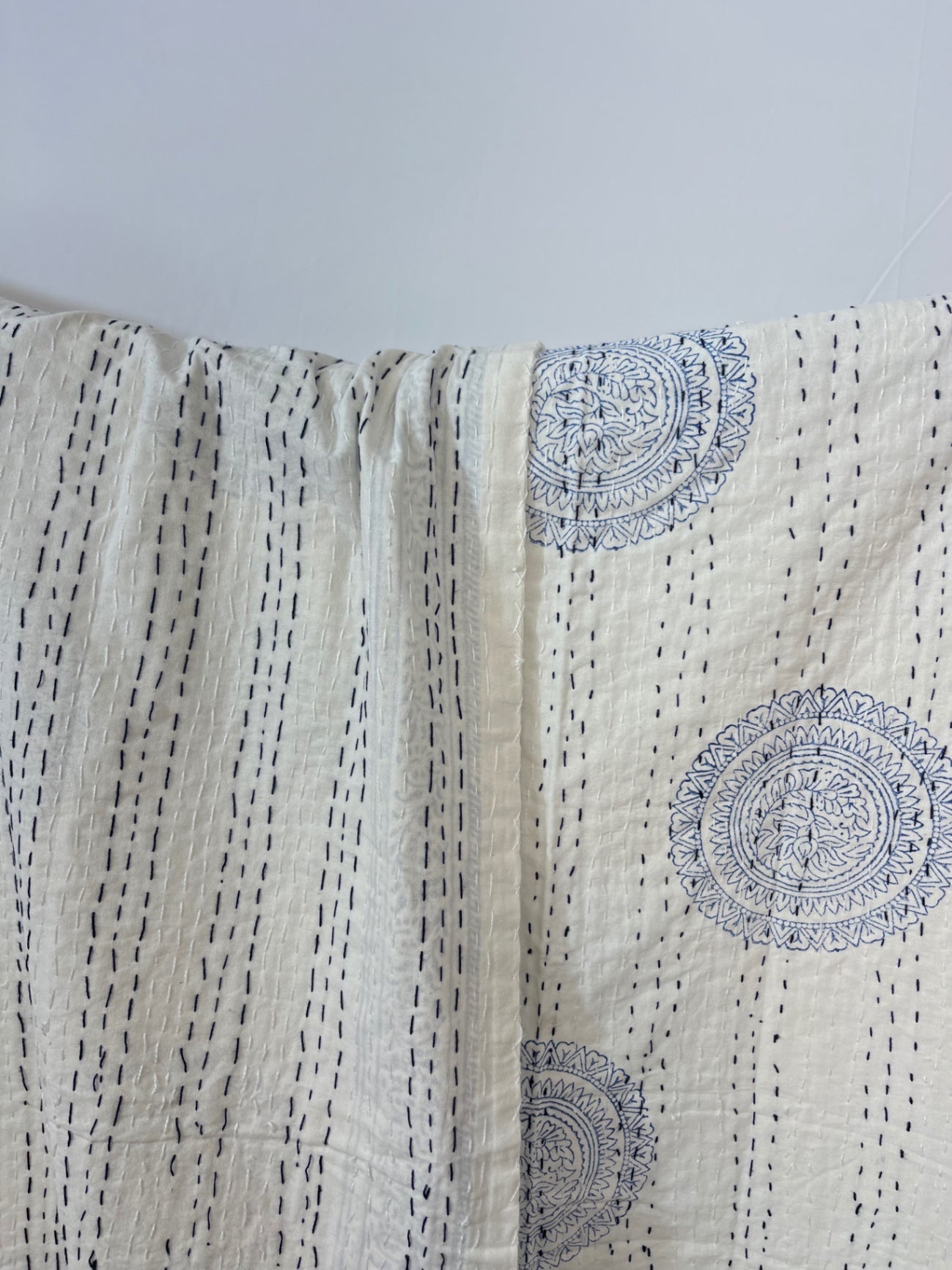 Textile with blue circular patterns on a beige background