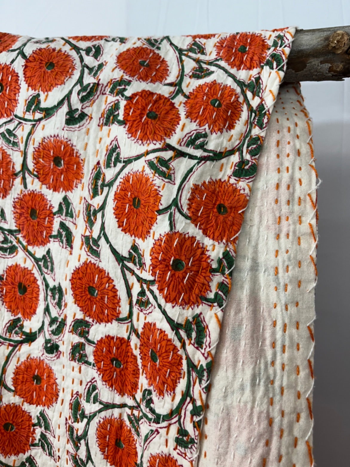 Floral patterned fabric with orange flowers on a white background