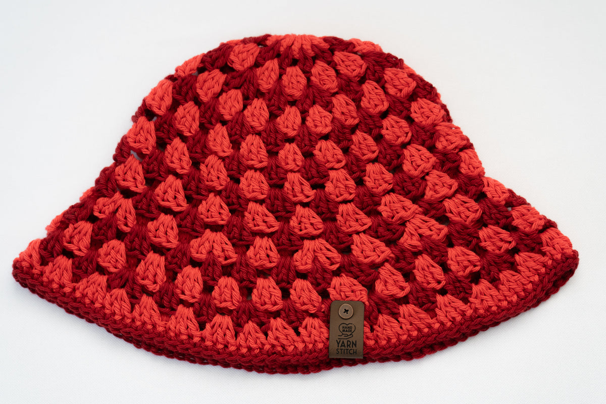 Red textured knit hat on a white background