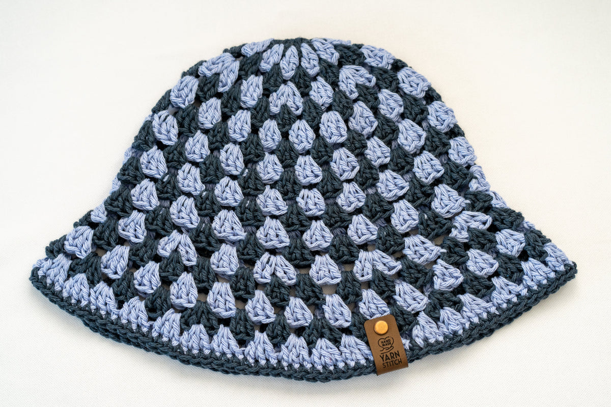 Crocheted beanie with a button on a white background