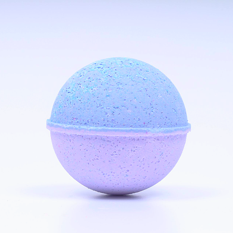 Speckled blue and purple bath bomb on a light purple background