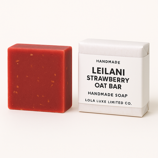 Red handmade soap bar next to its white packaging on a white background