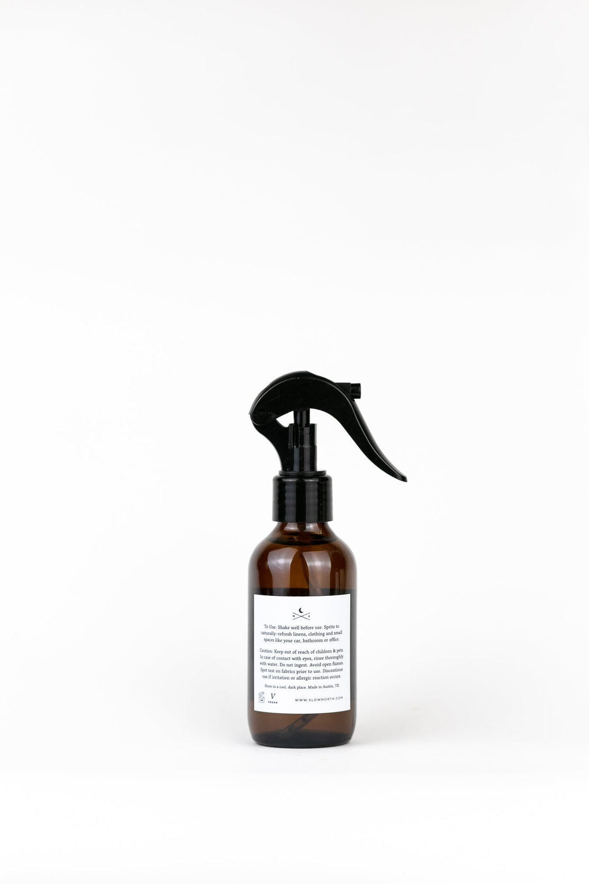 Brown spray bottle with black nozzle on a white background
