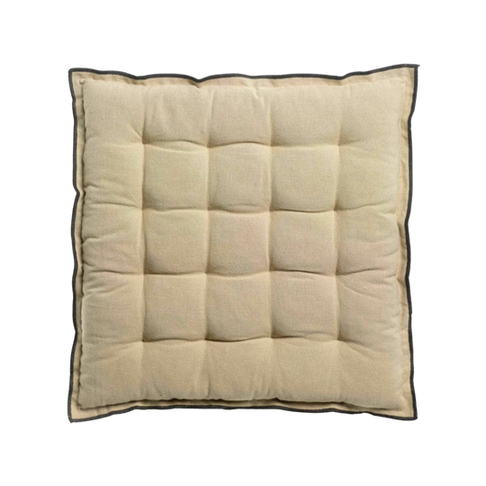 Beige quilted square cushion on a white background
