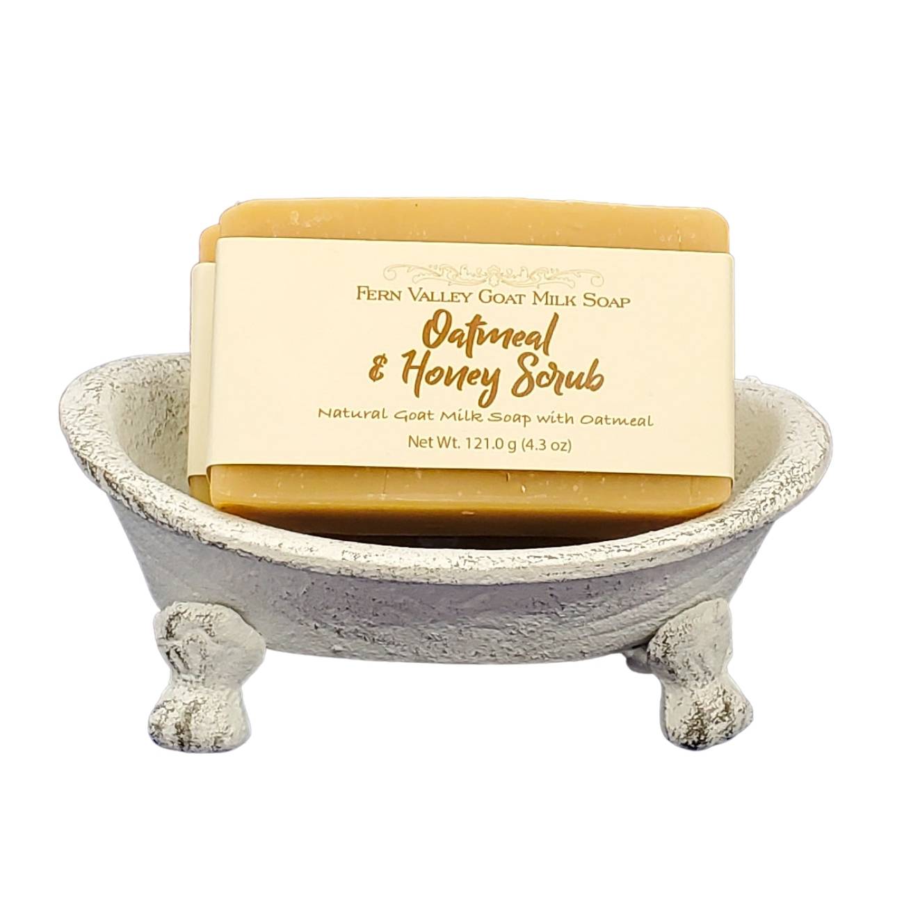 Bar of soap with a label in a small stone bathtub on a white background
