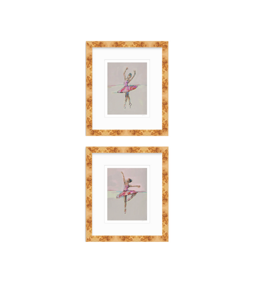 Two framed art prints featuring watercolor illustrations of ballerinas in pink tutus, arranged vertically on a white background. The prints are matted in white and enclosed in a textured, warm gold-brown frame.