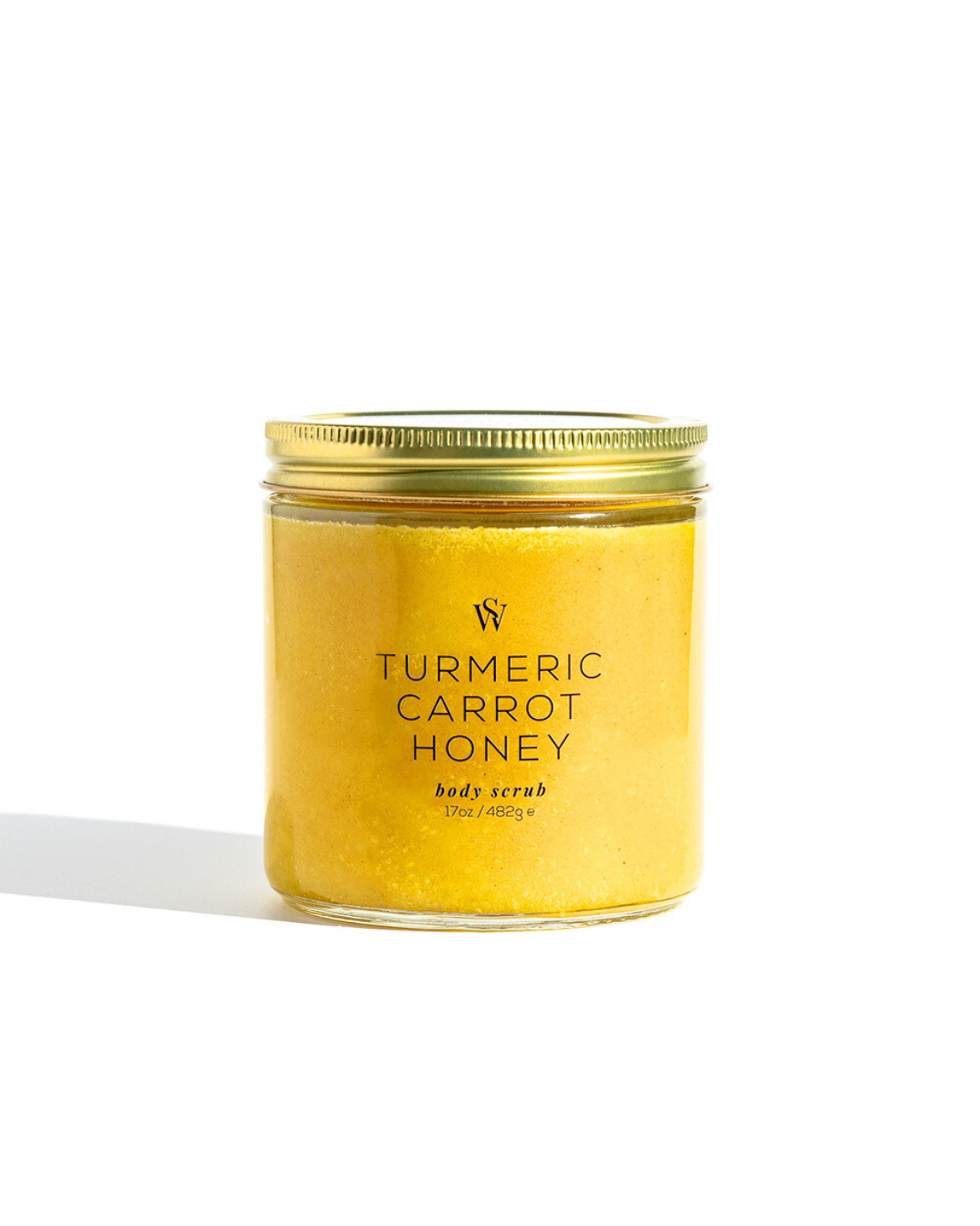 Jar of Turmeric Carrot Honey body scrub with a gold lid on a white background