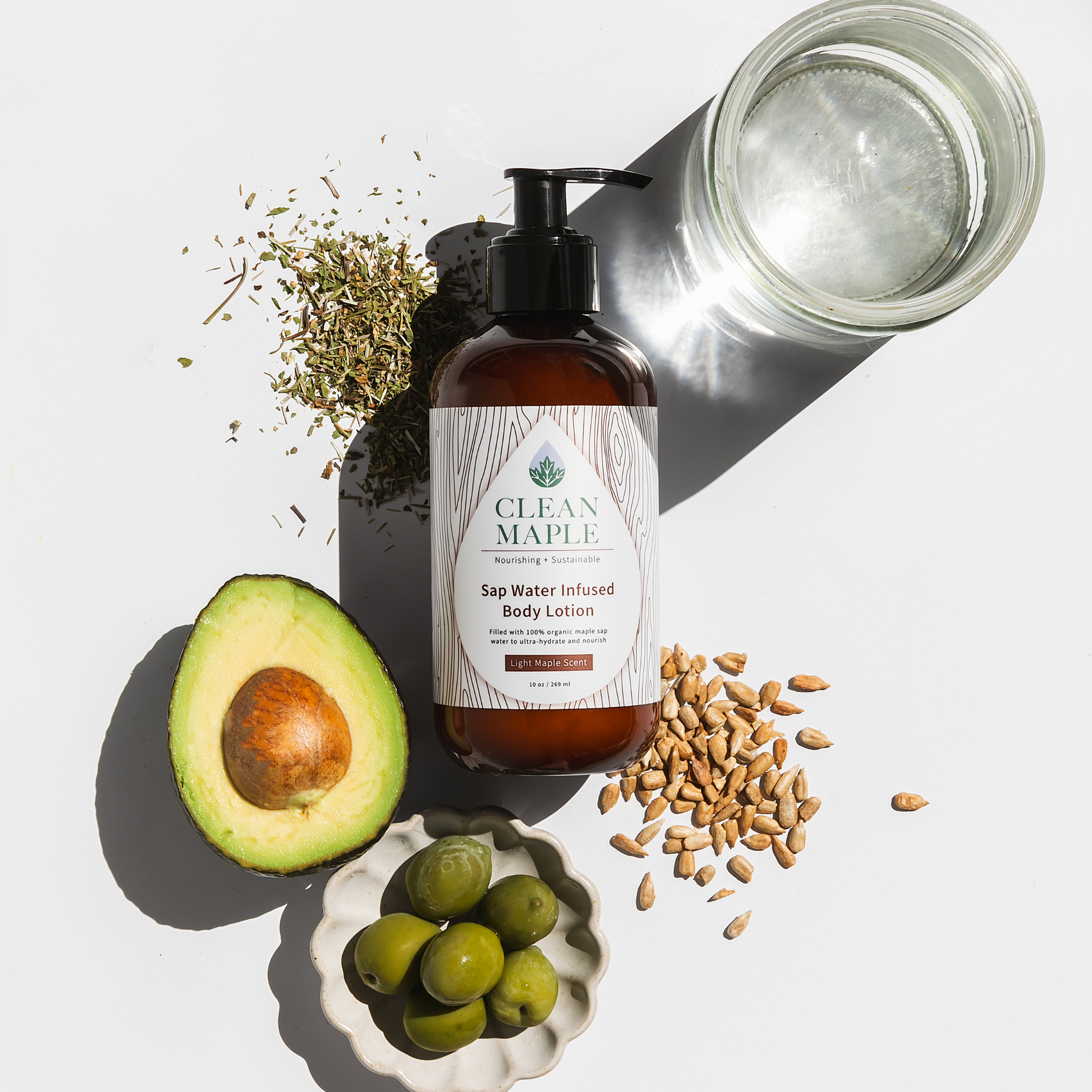 Body lotion bottle with natural ingredients on a white background