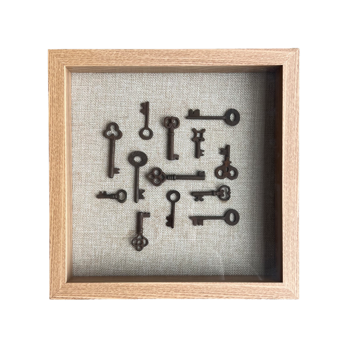 Framed collection of vintage keys on a textured gray background