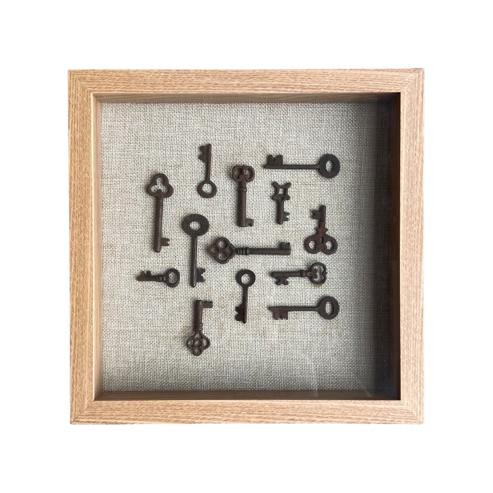 Framed collection of vintage keys on a textured gray background