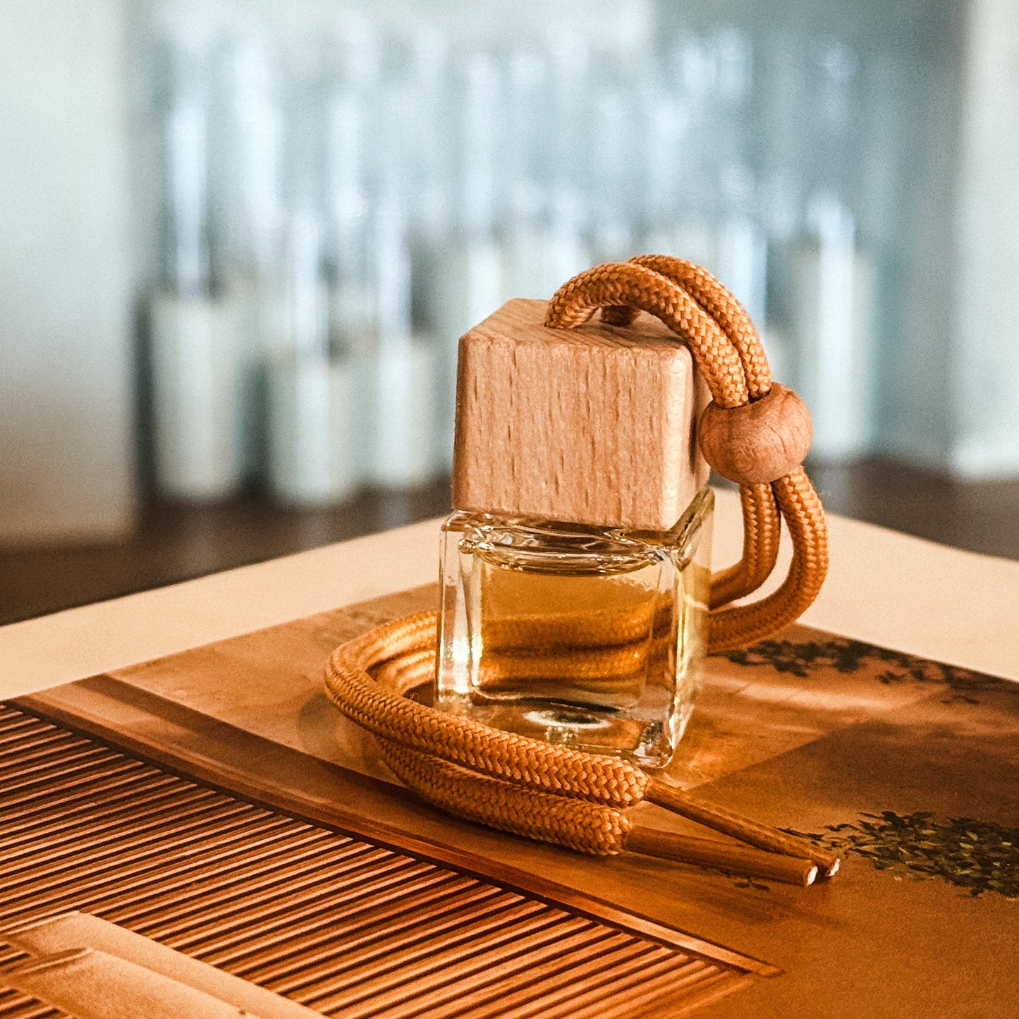 Perfume bottle with wooden cap on a wooden surface