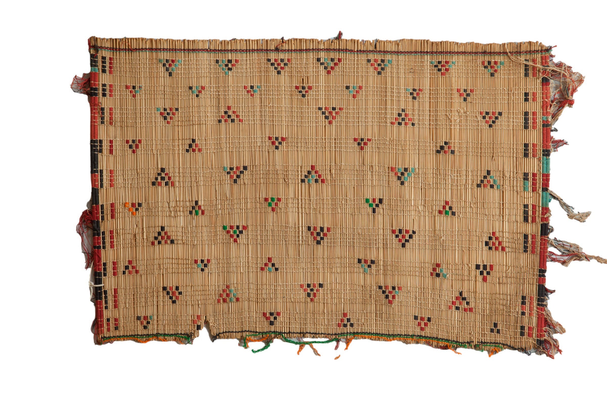Woven mat with geometric pattern on a white background
