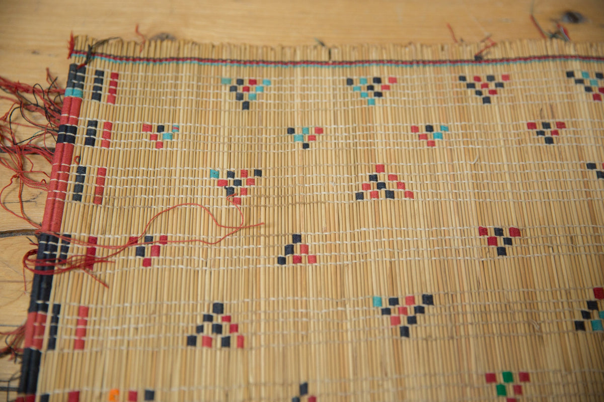Woven textile with geometric pattern on a wooden surface