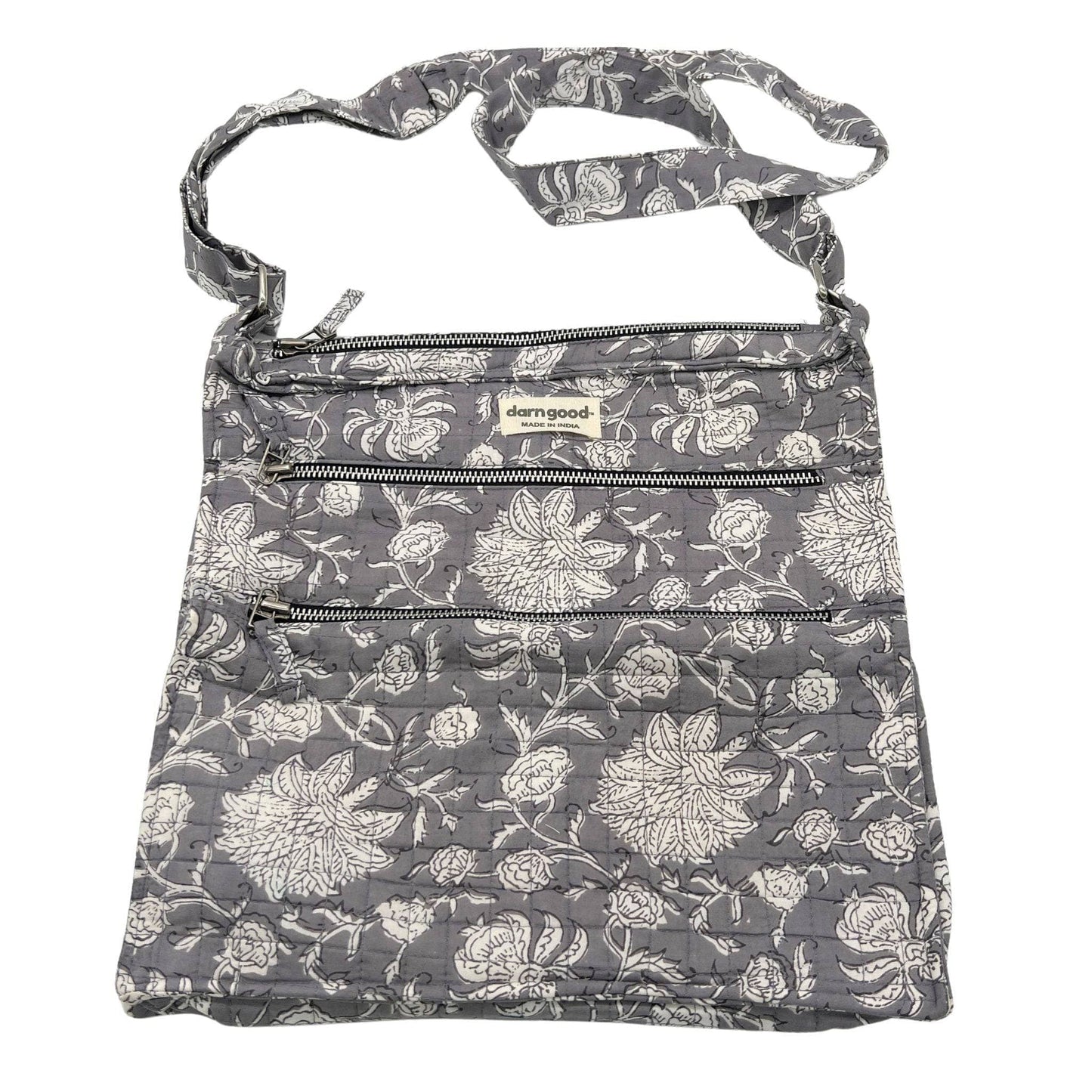 Floral patterned bag with zippers on a white background