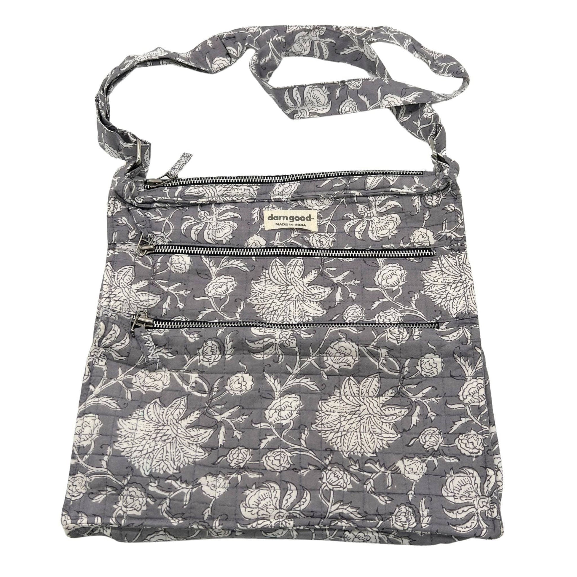 Floral patterned bag with zippers on a white background