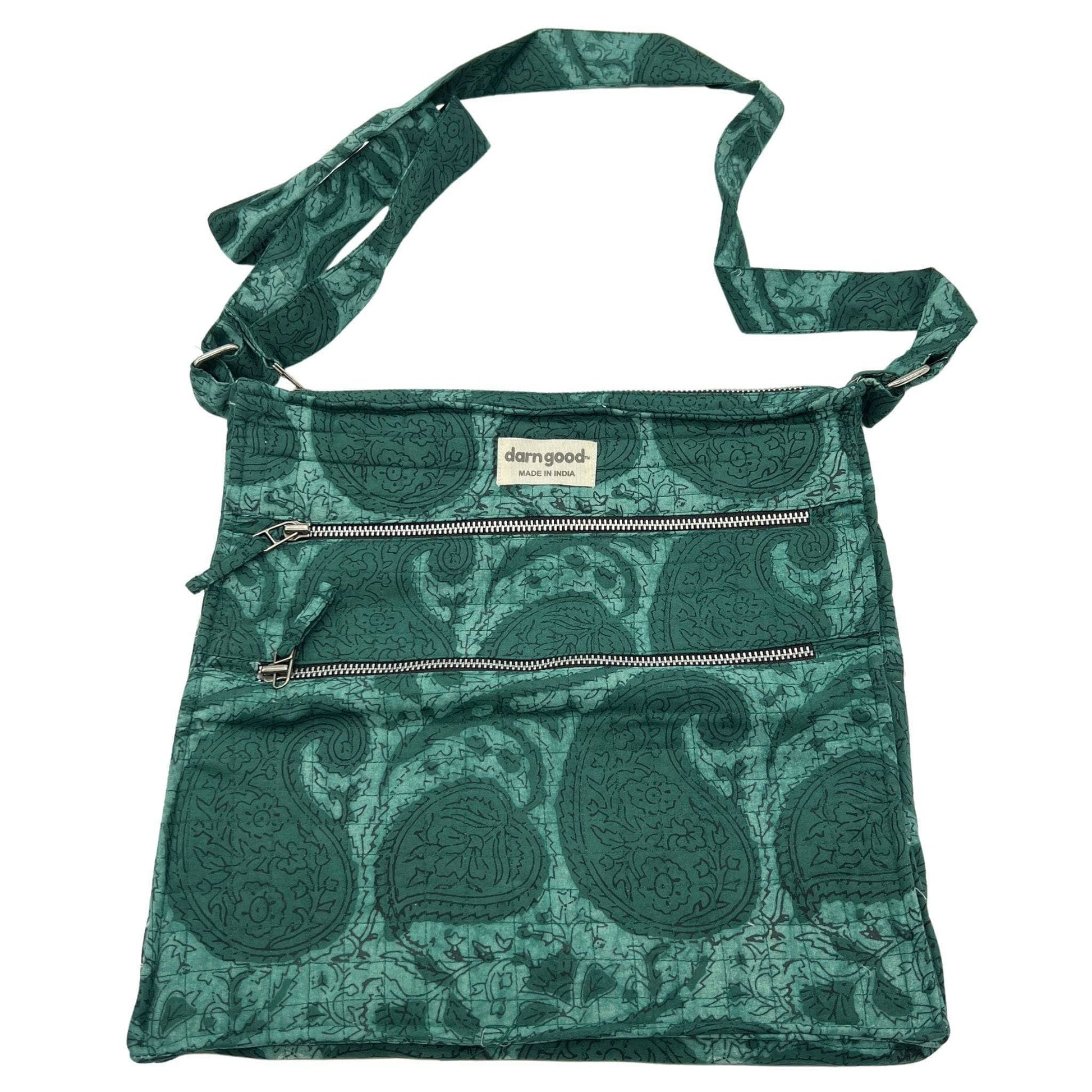 Green patterned bag with a visible brand label on a white background
